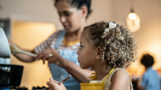 mother and her daughter cooking