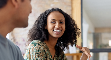 young women smiling at another perison