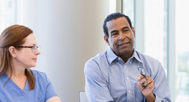 two people engaged in a meeting at work
