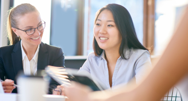 two women in an office meeting