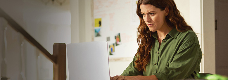 women on her laptop computer looking for a health care prior authorization