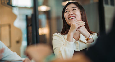 young women smiling and looking happy with her fellow employees