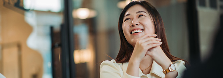 young women smiling and looking happy with her fellow employees