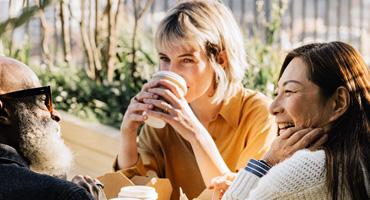 a group of employees on break enjoying a conversation on employee health benefits