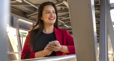 middle age women standing on a walking bridge smiling