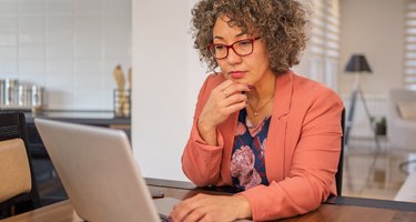 adult female sitting on a chair searching for Highmark health plans