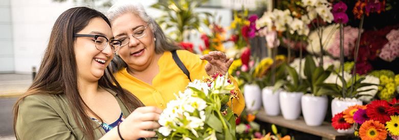 two women looking at flowers having a good time together