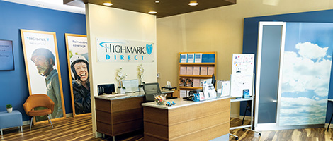 Inside of a Highmark direct store- shows desk, chair and Highmark signs