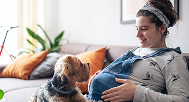 pregnant woman sitting with dog